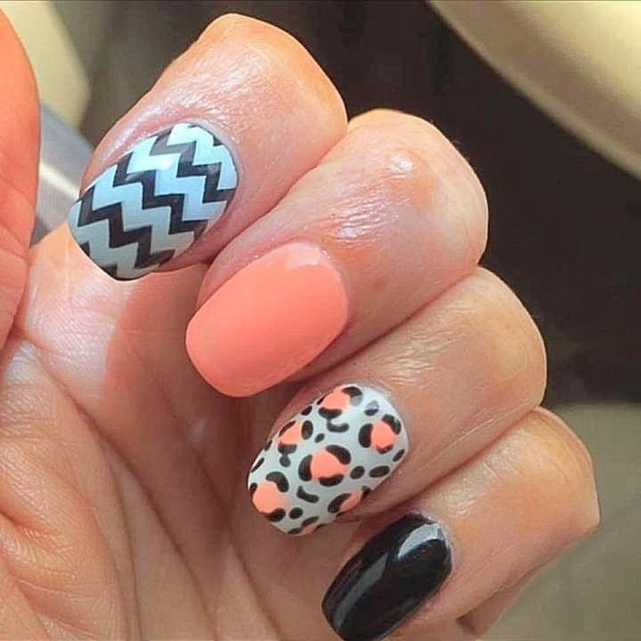 Coral acrylic nails with hand-painted chevron nail art by an OKC nail technician