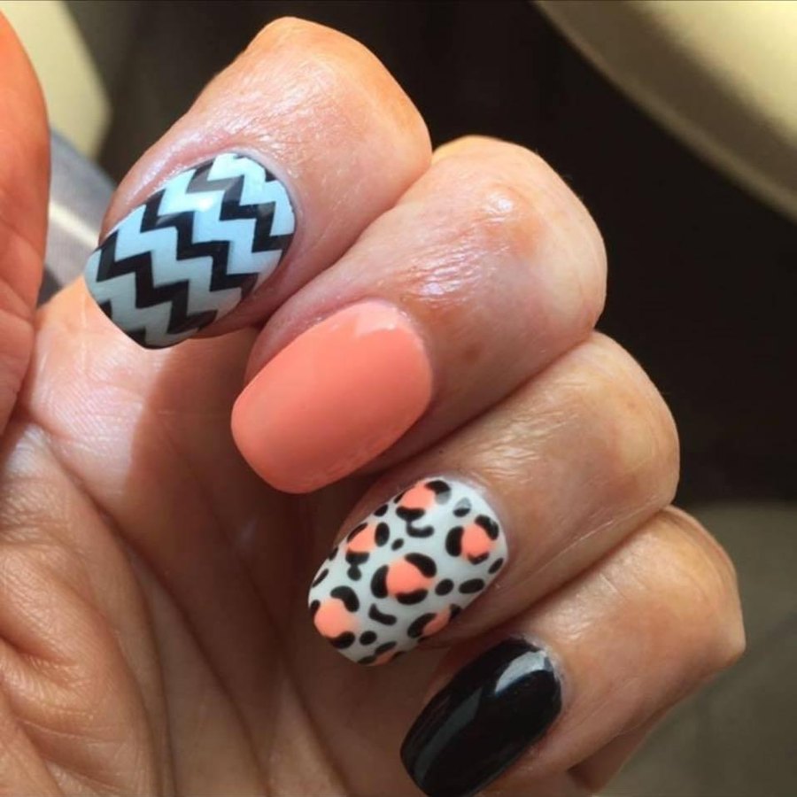 Peach acrylic nail set with chevron and leopard print nail art in Oklahoma City